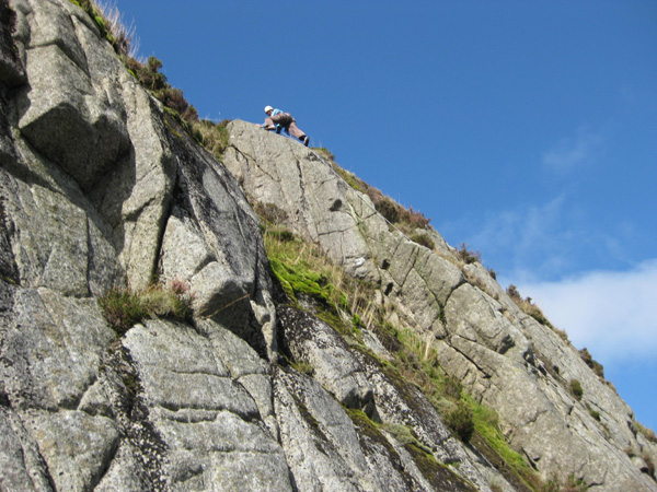 Linda Biggar topping out on the first ascent of The Sugar Loafers, Severe, Slab of the Spout, Cairnsmore of Fleet.